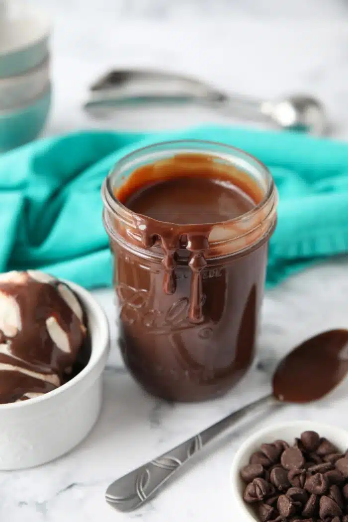 Hot fudge dripping down the side of a mason jar.