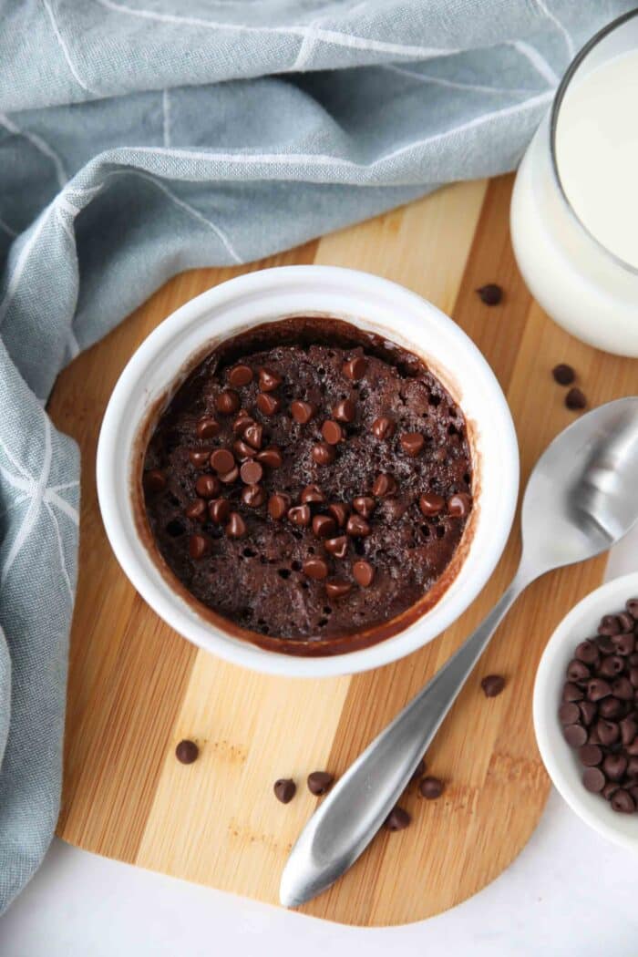 Top view of a microwave chocolate cake win a ramekin with chocolate chips on top.