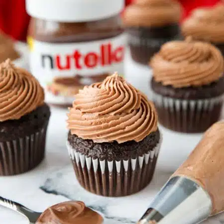 Nutella frosting piped on top of a chocolate cupcake.