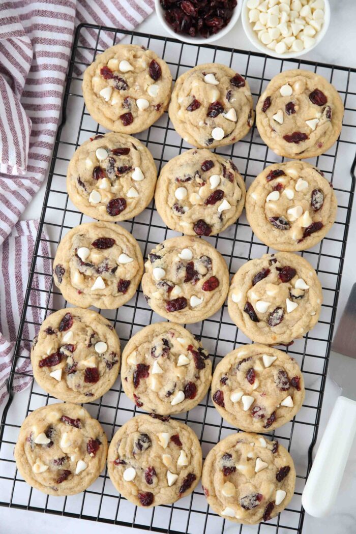Wire cooling rack with white chocolate chip cranberry cookies.