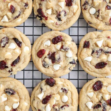 Close up of cranberry white chocolate cookies on a wire cooling rack.