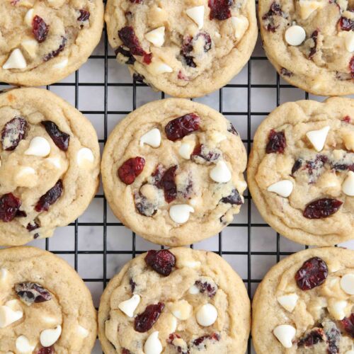 Close up of cranberry white chocolate cookies on a wire cooling rack.