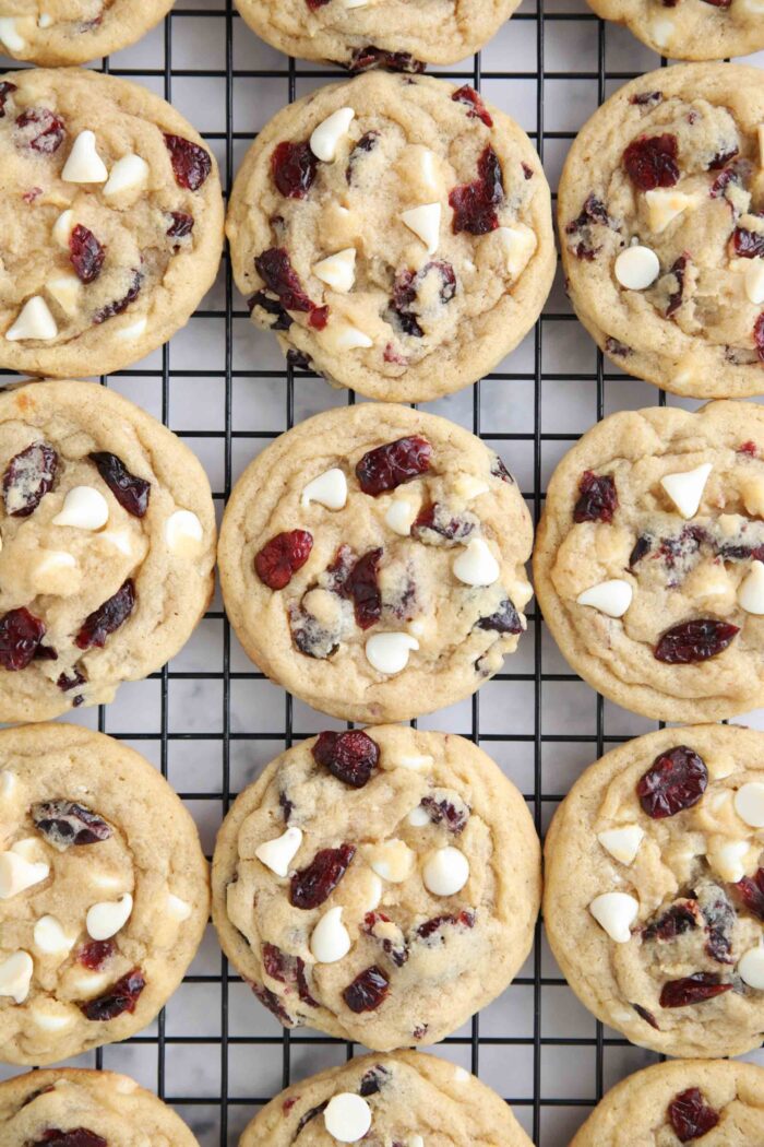 Close up of cranberry white chocolate cookies on a wire cooling rack.