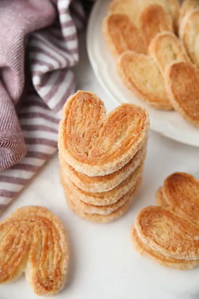 Stack of palmier cookies with a golden sugary crust.