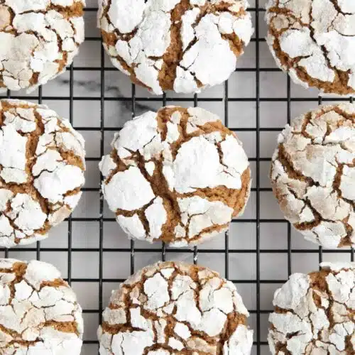 Gingerbread Christmas crinkle cookies on a wire cooling rack.
