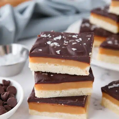 A stack of millionaire shortbread bars stacked on top of each other.