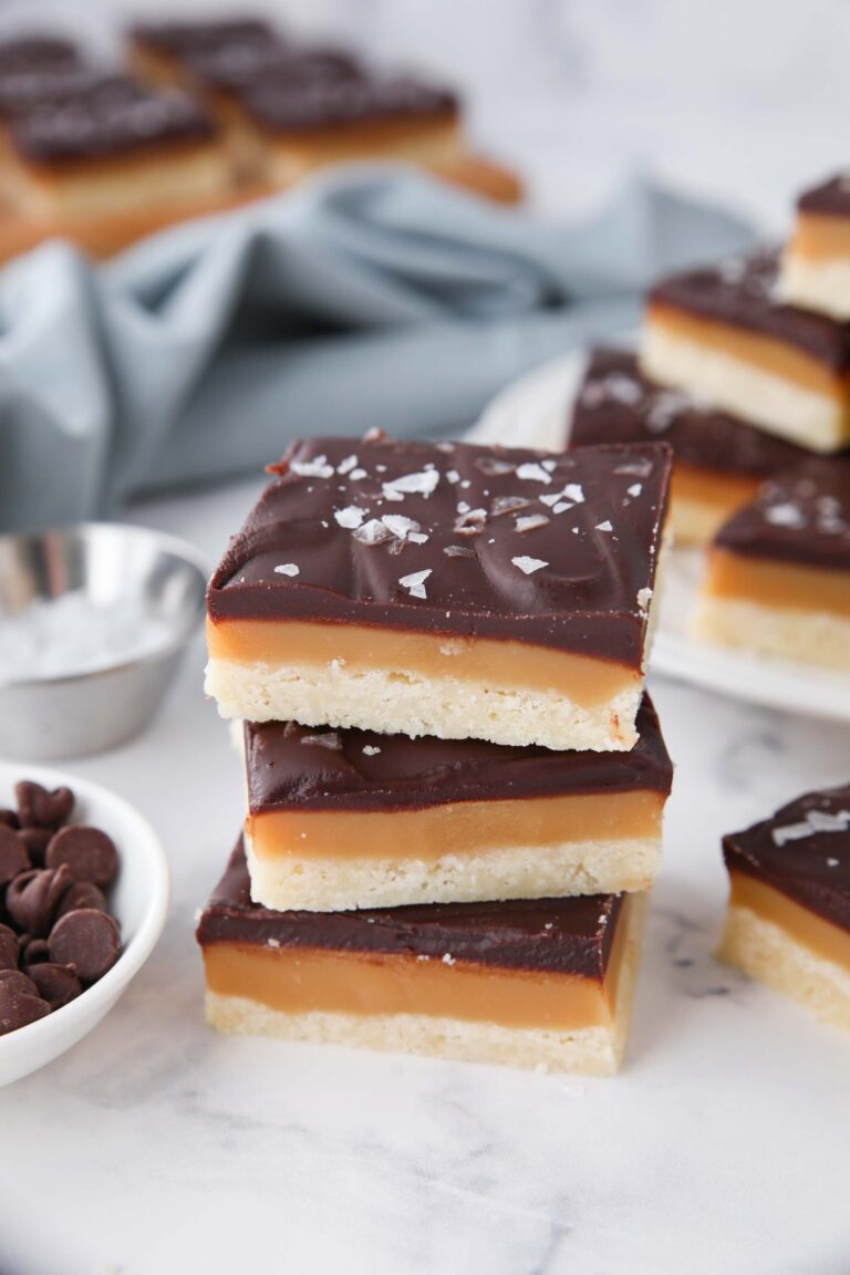 A stack of millionaire shortbread bars stacked on top of each other.