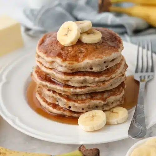 Stack of fluffy banana pancakes made with a pancake mix.
