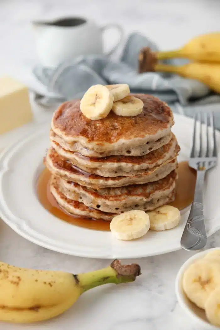 Stack of fluffy banana pancakes made with a pancake mix.
