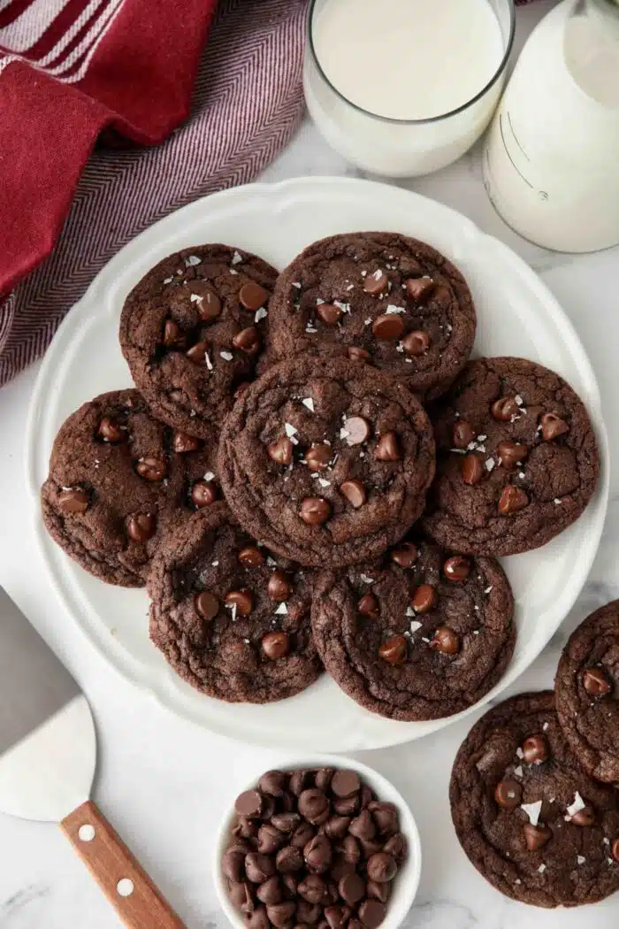 Plate of double chocolate chip cookies with flaky sea salt sprinkled on top.