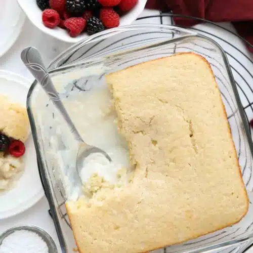 Top view of vanilla pudding cake in a baking pan with vanilla cake on top and vanilla pudding on bottom.