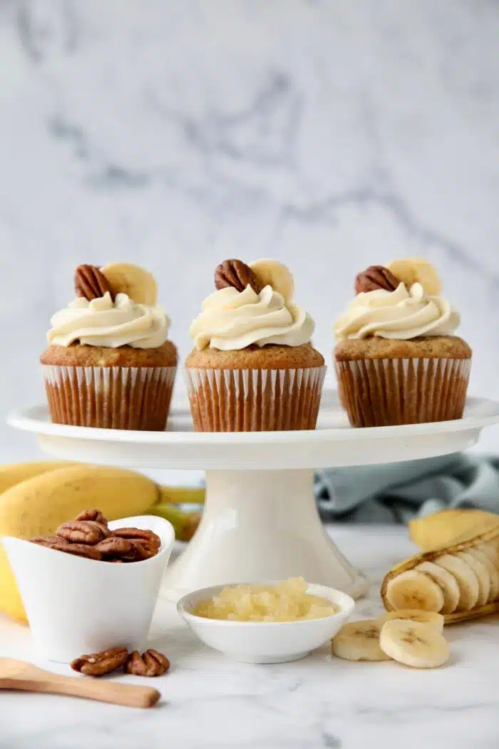 Hummingbird Cupcakes made with bananas, pineapple, and pecans and topped with cream cheese frosting.