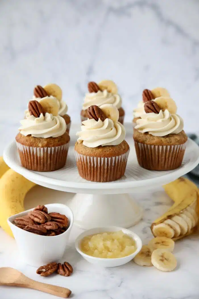 Cake plate with banana pineapple pecan cupcakes, aka hummingbird cupcakes.