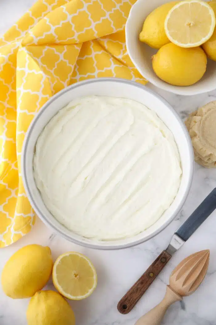 Lemon buttercream frosting in a large bowl.
