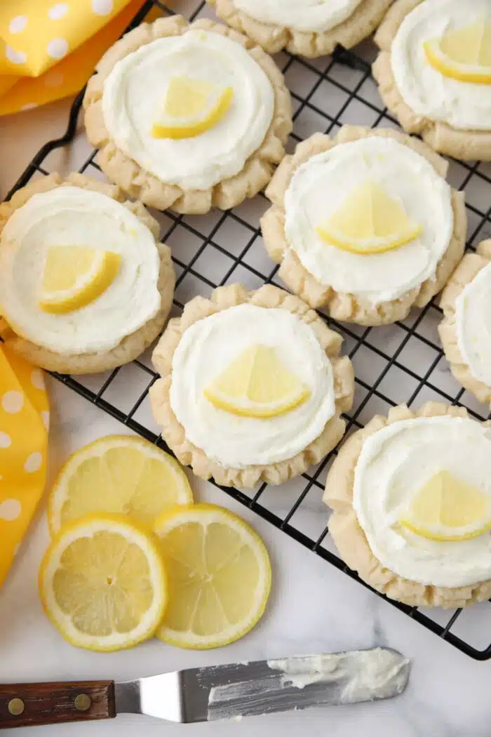 Top view of lemon sugar cookies with lemon frosting on a wire cooling rack.