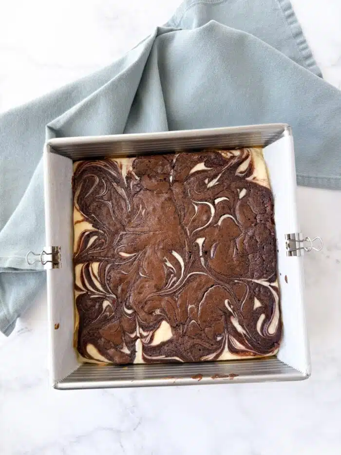 Cheesecake swirl brownies in pan.